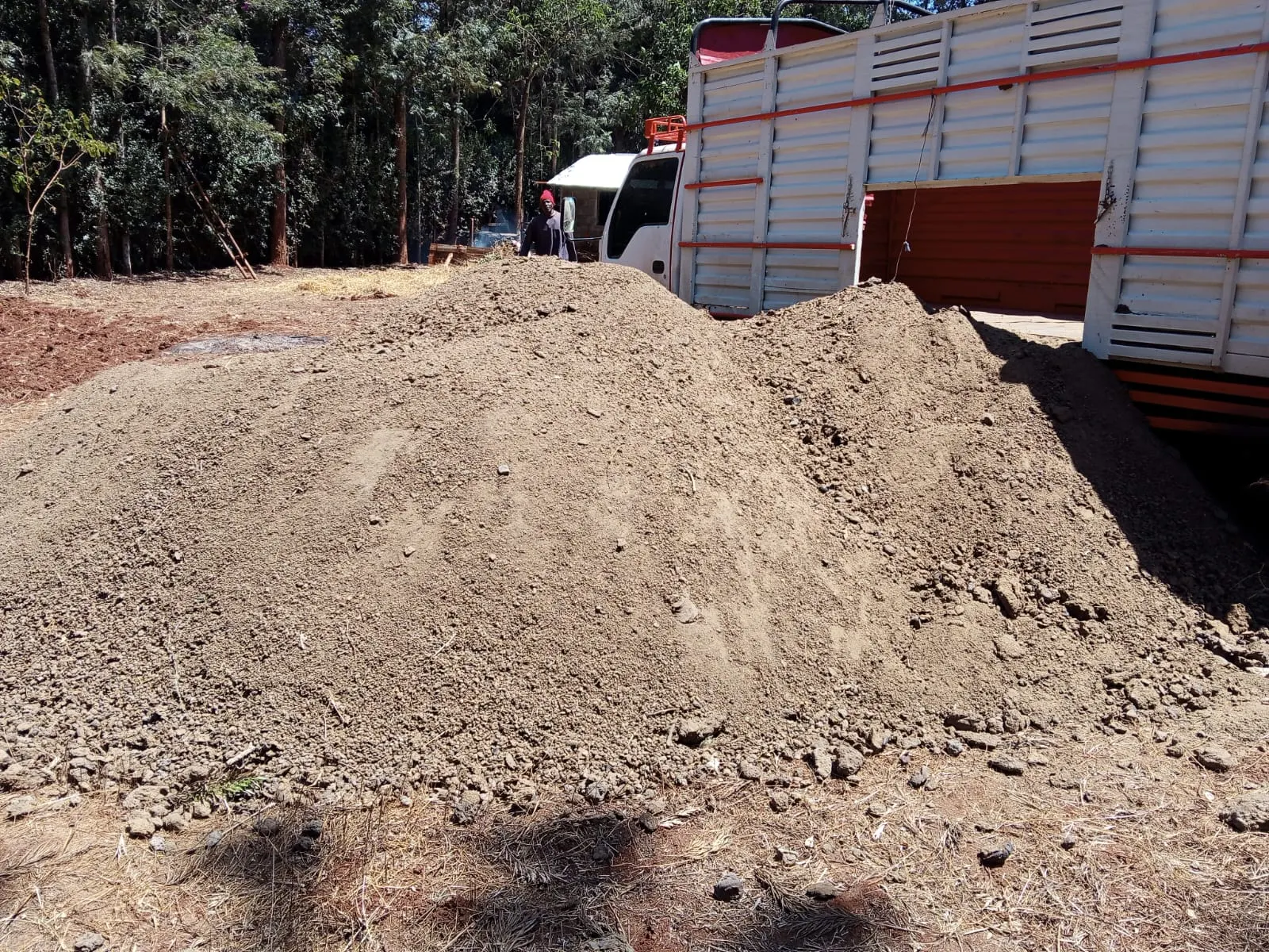 Two loads of goat manure delivered to a farm yard